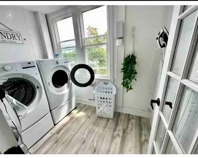 a laundry room with a washing machine and a window at 10-A Diamond in Yonkers, NY in Yonkers
