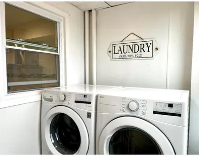 a washer and dryer in a laundry room with a sign at 10-A Diamond in Yonkers, NY in Yonkers
