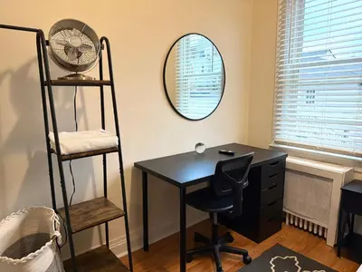 a room with a desk and a fan and a mirror at 10-A Diamond in Yonkers, NY in Yonkers