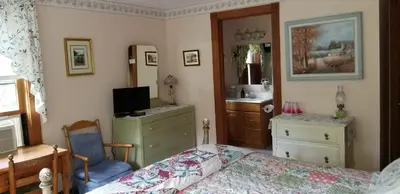 a bedroom with a bed and a desk and a television at Eastgate Inn B&B in Lenox