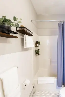 a bathroom with white walls and a blue shower curtain at Downtown New Haven, Spacious Stay by Yale - AO Destinations in New Haven