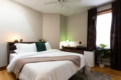 a bedroom with a large bed and a window at Downtown New Haven, Spacious Stay by Yale - AO Destinations in New Haven