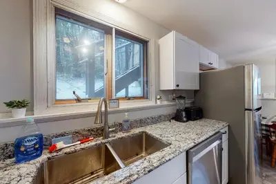 a kitchen with a sink and a window at Gone Ski inn in West Dover