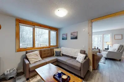 a living room with a couch and a table at Gone Ski inn in West Dover