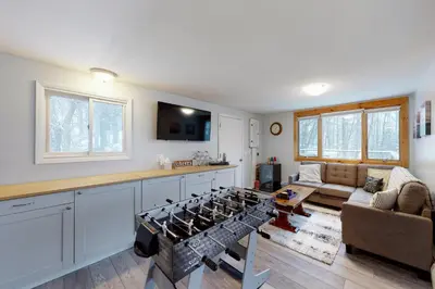 a kitchen with a stove top oven in a living room at Gone Ski inn in West Dover
