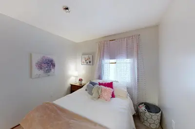 a bedroom with a white bed and a window at Gone Ski inn in West Dover