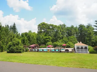 a park with a pool and a gazebo at Woodfield Manor - A Sundance Vacations Property in Cresco