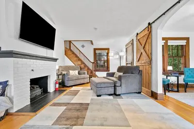 a living room with a fireplace and a tv at Quintessential Cozy Haven, Brooklawn Beauty in Bridgeport