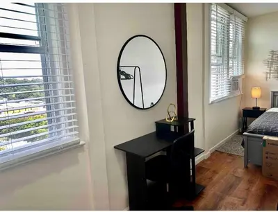 a mirror on a wall in a room with a desk at 0-A Diamond in Yonkers, NY in Yonkers