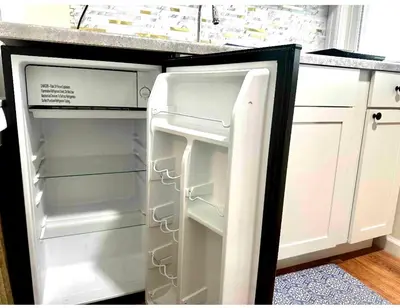 an empty refrigerator with its door open in a kitchen at 0-A Diamond in Yonkers, NY in Yonkers