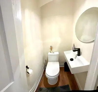 a bathroom with a white toilet and a sink at 0-A Diamond in Yonkers, NY in Yonkers