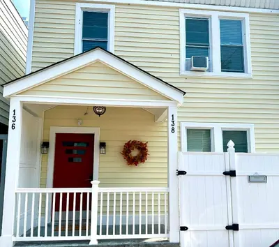 a house with a red door and a white fence at 0-A Diamond in Yonkers, NY in Yonkers