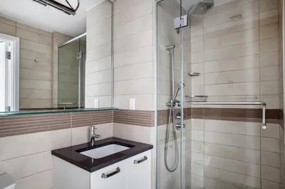 a bathroom with a sink and a shower at Gorgeous Midtown W 1BR w Gym nr Times Sq NYC-651 in New York