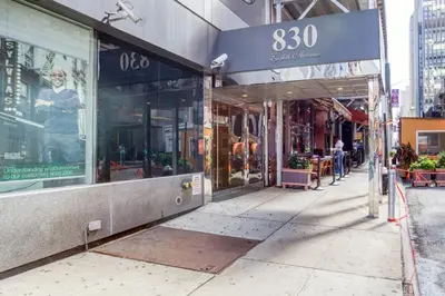 a row of shops on a city street at Gorgeous Midtown W 1BR w Gym nr Times Sq NYC-651 in New York