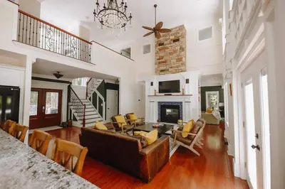 a living room with a couch and a fireplace at The Athena Hideaway - hottub, firepit, lake & racetrack in Saratoga Springs
