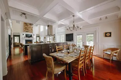 a kitchen and dining room with a table and chairs at The Athena Hideaway - hottub, firepit, lake & racetrack in Saratoga Springs