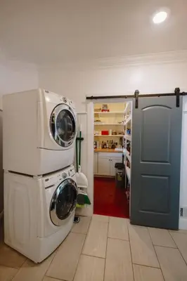 a kitchen with a washer and dryer in a room at The Athena Hideaway - hottub, firepit, lake & racetrack in Saratoga Springs