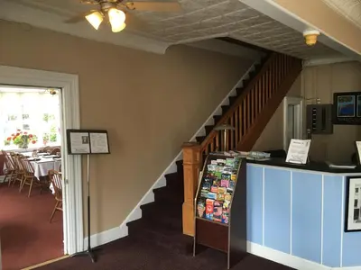 a staircase leading up to a room with a store at The Tunnicliff Inn in Cooperstown