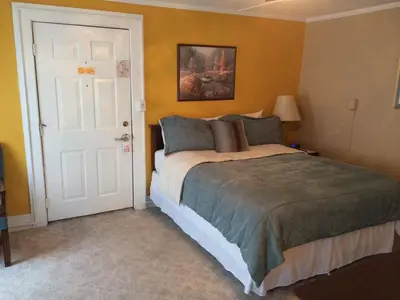 a bedroom with a bed and a white door at The Tunnicliff Inn in Cooperstown