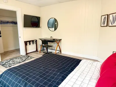 a bedroom with a bed and a table and a table at 1-A Diamond in Yonkers, NY in Yonkers