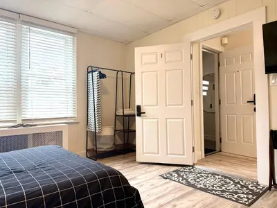 a bedroom with a bed and a shower and a door at 1-A Diamond in Yonkers, NY in Yonkers
