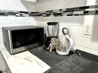 a kitchen counter with a microwave and a blender at 1-A Diamond in Yonkers, NY in Yonkers