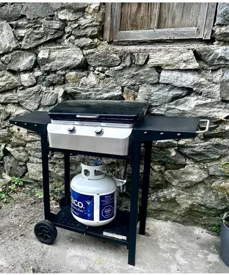 a grill with a pot on a table in front of a stone wall at 1-A Diamond in Yonkers, NY in Yonkers