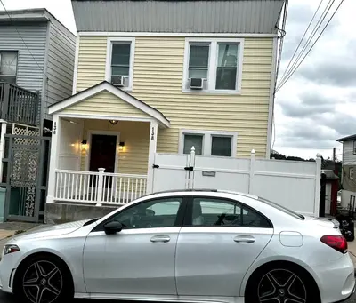 a white car parked in front of a house at 1-A Diamond in Yonkers, NY in Yonkers