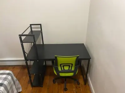 a black desk with a green chair in a room at Frog Hollow Red Door Haven in Hartford