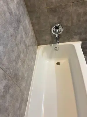a white bath tub with a faucet in a bathroom at Frog Hollow Red Door Haven in Hartford