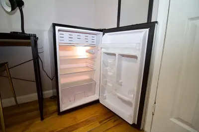 an empty refrigerator with its door open in a room at Tuk Ahoy - Emerald Suite 3C with Shared Spaces in Brooklyn
