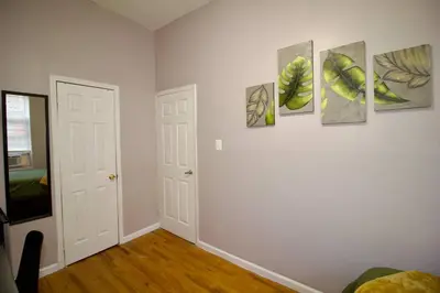 a room with five paintings on the wall at Tuk Ahoy - Emerald Suite 3C with Shared Spaces in Brooklyn