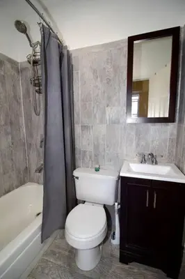 a bathroom with a toilet and a sink and a tub at Tuk Ahoy - Emerald Suite 3C with Shared Spaces in Brooklyn