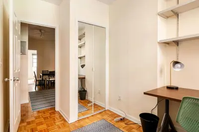 a hallway with a table and a dining room at ✪ Large 2 Bedrooms ✪ Queen Beds ✪ Work Stations in New York