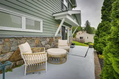 a patio with two chairs and a table at New Fairfield Vacation Rental with Lake Views! in New Fairfield