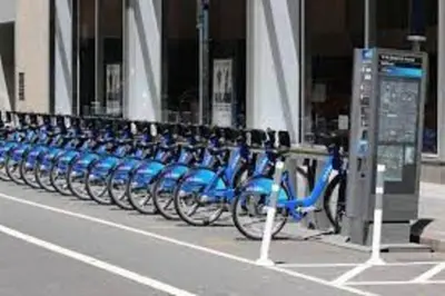 a row of blue bikes parked in front of a building at Comfortable Apartment with Workstation in New York