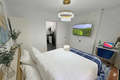a bedroom with a large white bed in a room at Comfortable 2BR & 2 Bath Apt in Downtown NYC in New York