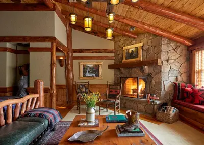 a living room with a couch and a fireplace at The Chatwal Lodge (All-Inclusive) - in The Unbound Collection by Hyatt in White Lake
