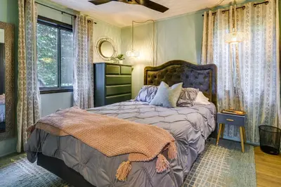 a bedroom with a bed and a window at Deck, Fire Pit and Sauna Big Bass Lake Getaway! in Clifton