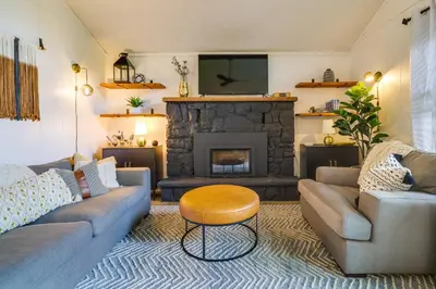 a living room with a couch and a fireplace at Deck, Fire Pit and Sauna Big Bass Lake Getaway! in Clifton
