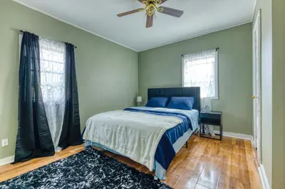a bedroom with a bed and a ceiling fan at Humble home with free breakfast offered if requested! in Chicopee