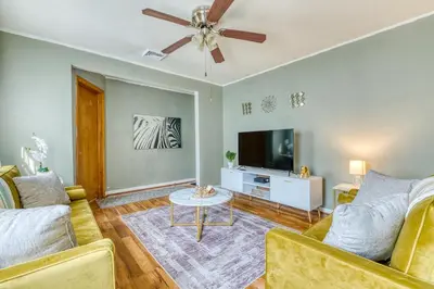 a living room with a couch and a flat screen tv at Humble home with free breakfast offered if requested! in Chicopee