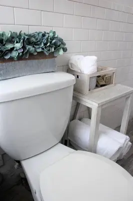 a bathroom with a toilet and a plant on a table at Elegant 3Br Apt Yankee stadium in Melrose