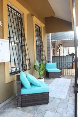 a patio with two blue chairs and a plant at Elegant 3Br Apt Yankee stadium in Melrose