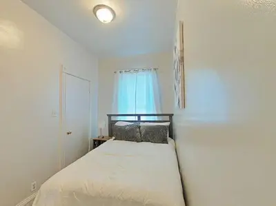 a bedroom with a bed with a blue window at Elegant 3Br Apt Yankee stadium in Melrose