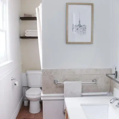 a white bathroom with a toilet and a sink at Historic peaceful apartment in New Haven