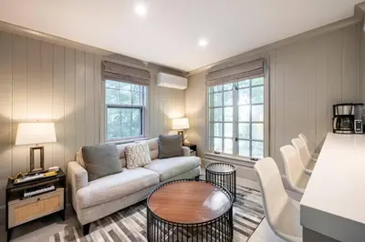 a living room with a couch and a table at Exquisite Bedford Lux Retreat. in Bedford