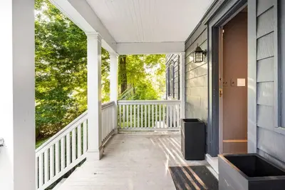 an empty porch of a house with a window at Exquisite Bedford Lux Retreat. in Bedford