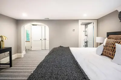 a bedroom with a large white bed and a hallway at Exquisite Bedford Lux Retreat. in Bedford