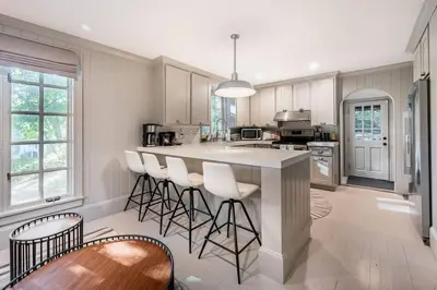 a kitchen with a large island with bar stools at Exquisite Bedford Lux Retreat. in Bedford
